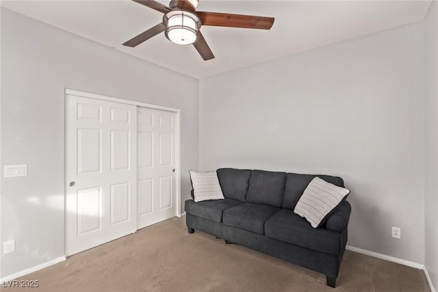 sitting room featuring ceiling fan and carpet