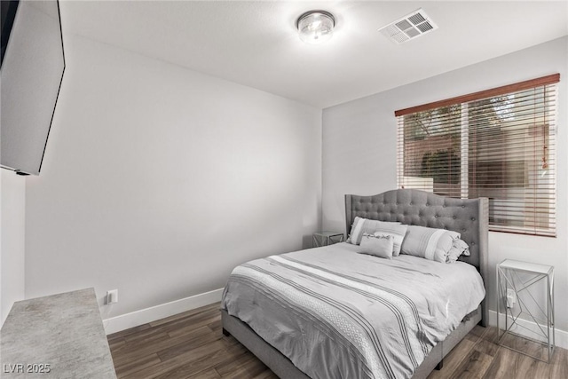 bedroom with dark wood-type flooring