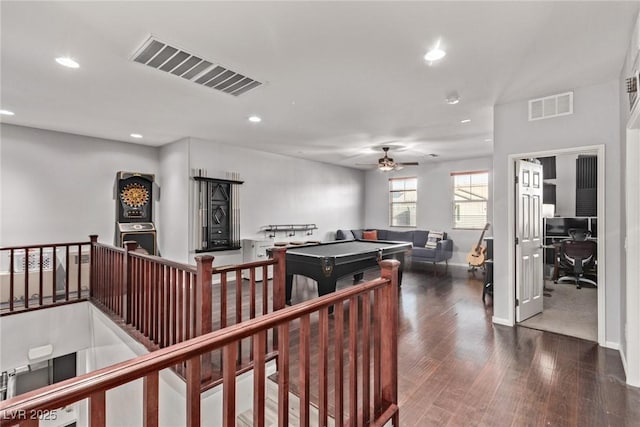 interior space with ceiling fan and dark hardwood / wood-style flooring