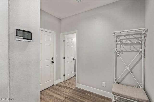 corridor with hardwood / wood-style floors