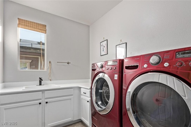 washroom with sink, cabinets, and independent washer and dryer