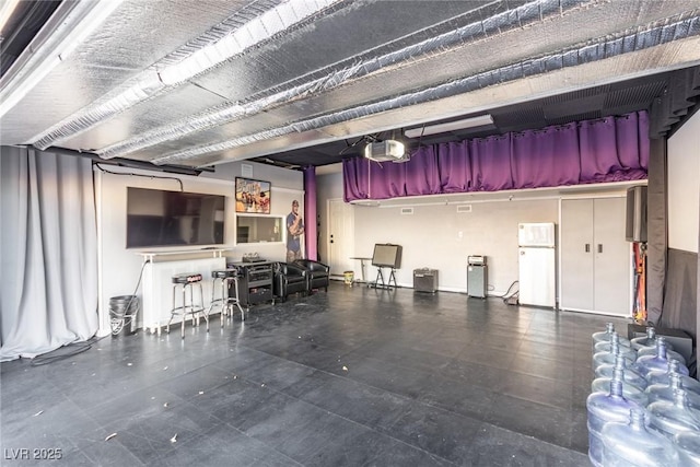 garage with a garage door opener and white refrigerator