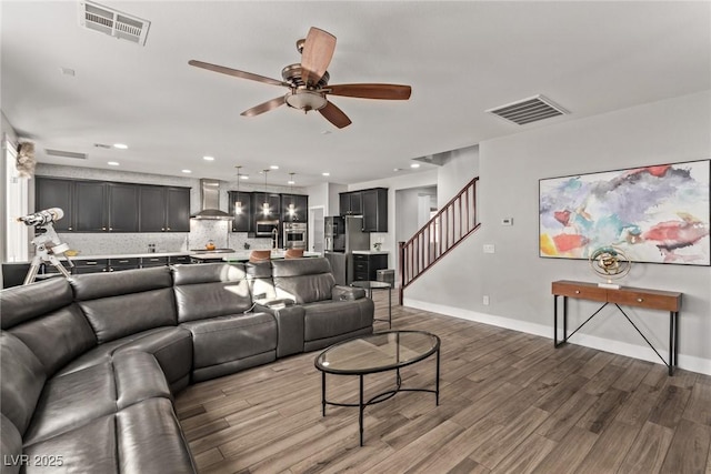 living room featuring ceiling fan and wood-type flooring