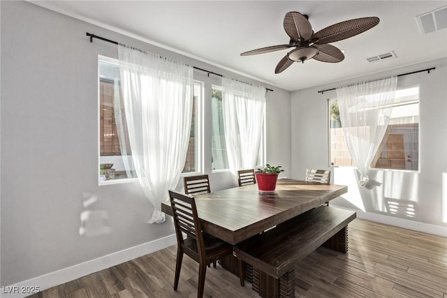 dining room with hardwood / wood-style flooring and ceiling fan