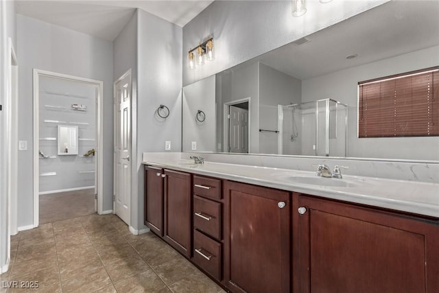 bathroom with a shower with door and vanity