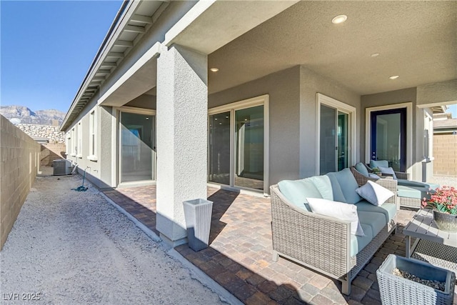 view of patio / terrace featuring a mountain view, cooling unit, and an outdoor hangout area