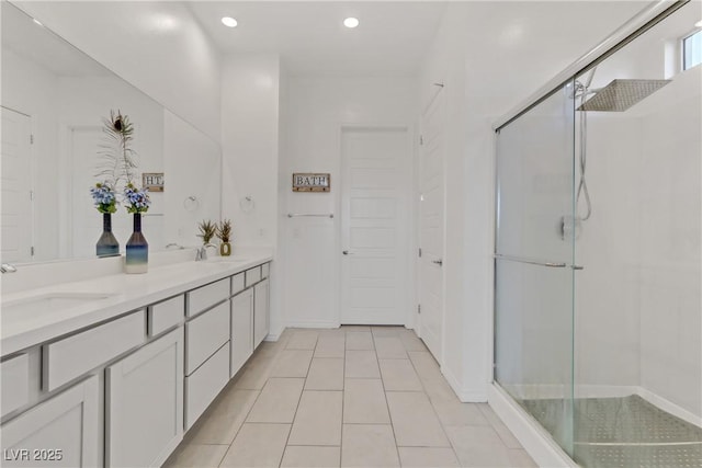 bathroom with tile patterned floors, walk in shower, and vanity