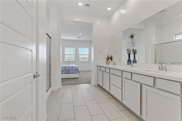 bathroom with vanity, a shower with shower door, and tile patterned floors