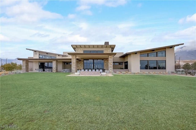 back of property featuring a patio and a yard