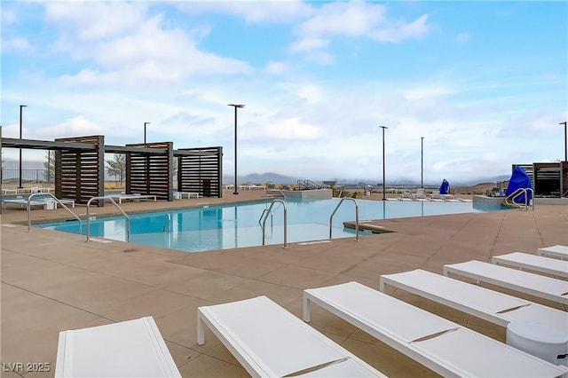 view of pool featuring a patio and a water view