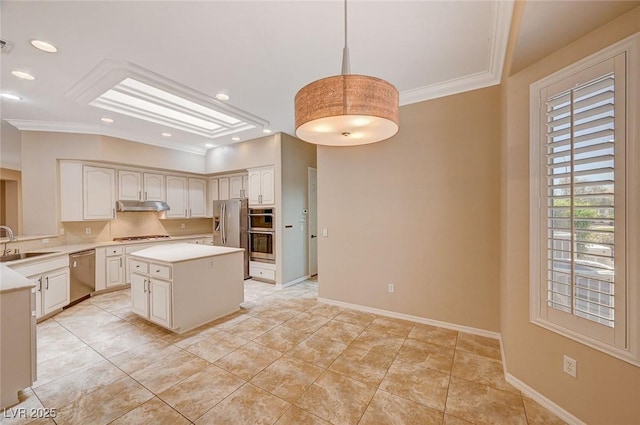 kitchen with hanging light fixtures, sink, ornamental molding, a kitchen island, and stainless steel appliances