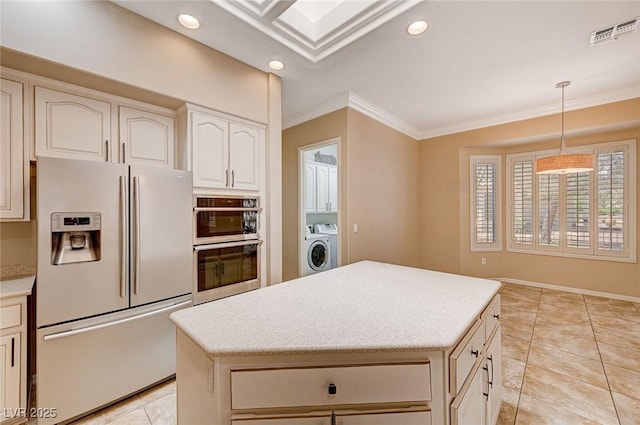 kitchen featuring decorative light fixtures, washer / clothes dryer, light tile patterned floors, ornamental molding, and stainless steel appliances