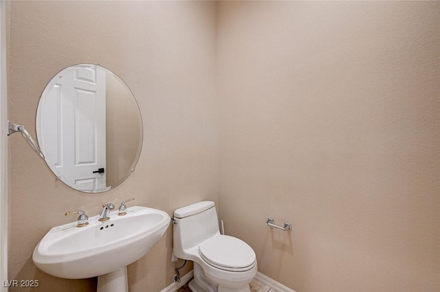 bathroom featuring sink and toilet