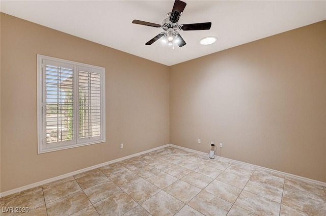 spare room featuring ceiling fan and light tile patterned floors