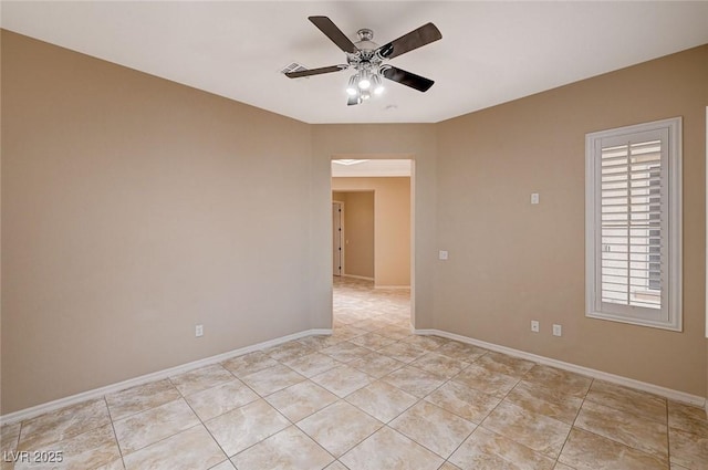 empty room with light tile patterned floors and ceiling fan