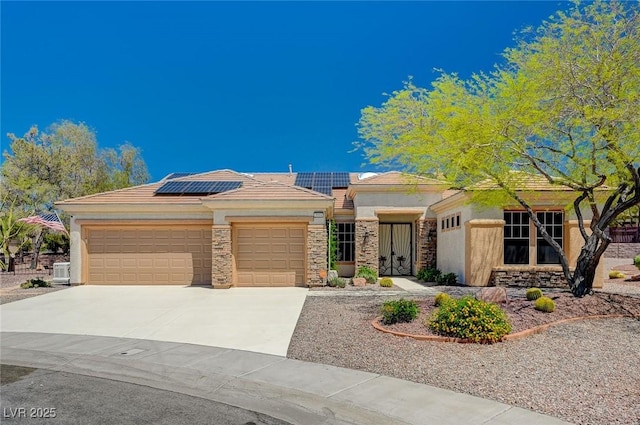 view of front of house with a garage and solar panels