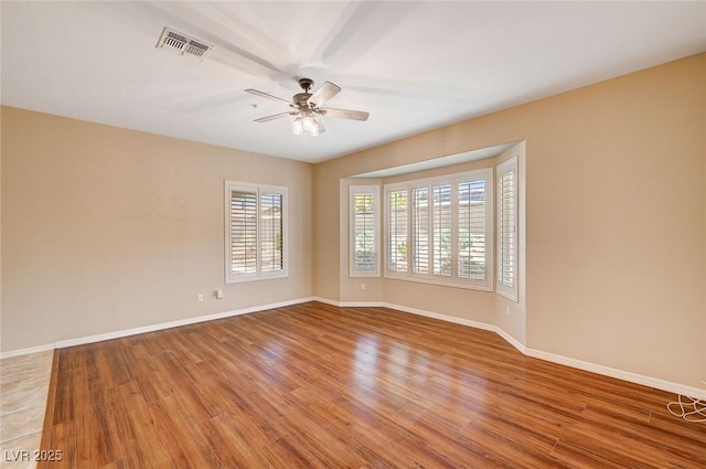 empty room with ceiling fan and wood-type flooring