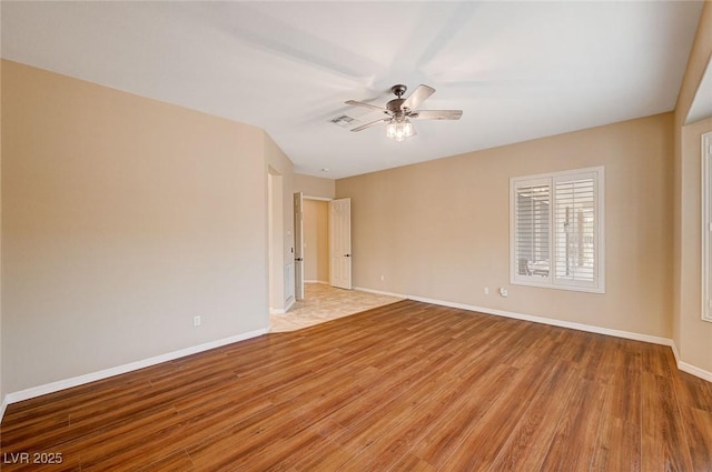 empty room with ceiling fan and wood-type flooring