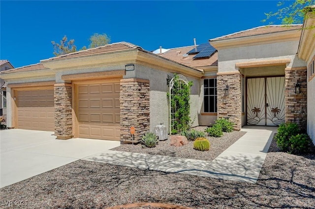 view of front of property featuring a garage and solar panels