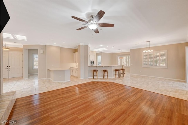 unfurnished living room with light hardwood / wood-style floors and ceiling fan