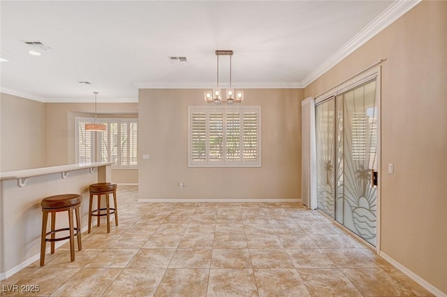 interior space with ornamental molding and an inviting chandelier