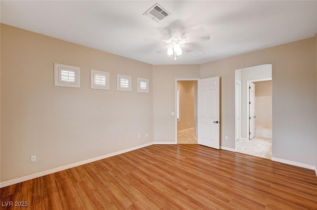 empty room featuring ceiling fan and light hardwood / wood-style floors