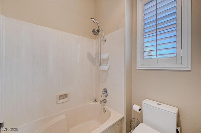 bathroom with bathing tub / shower combination and toilet