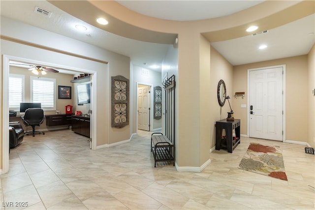 foyer entrance featuring ceiling fan