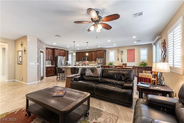 living room with light hardwood / wood-style floors and ceiling fan