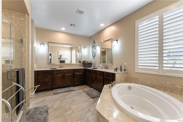 bathroom with separate shower and tub and vanity