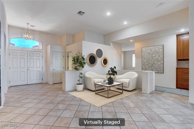 tiled foyer entrance with plenty of natural light and a chandelier