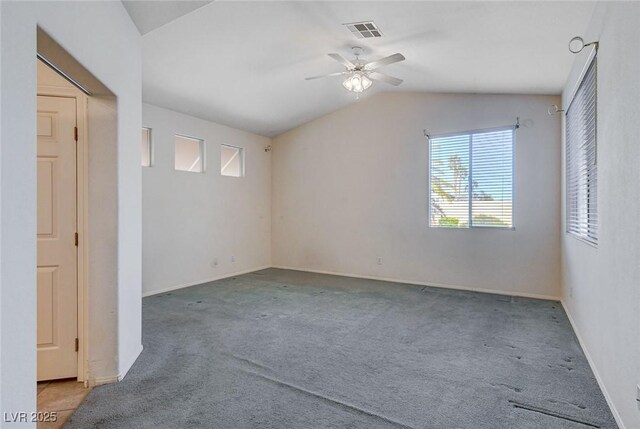 empty room featuring ceiling fan, carpet, and lofted ceiling