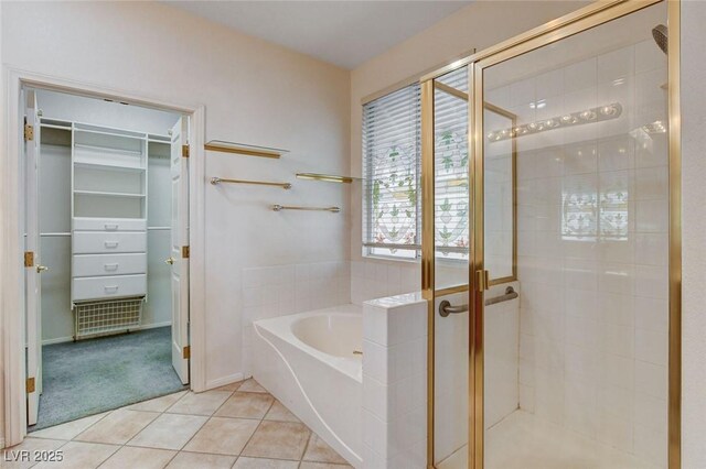 bathroom with tile patterned floors and independent shower and bath