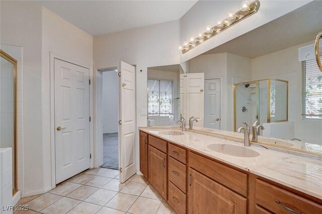 bathroom with vanity, a shower with shower door, and tile patterned flooring