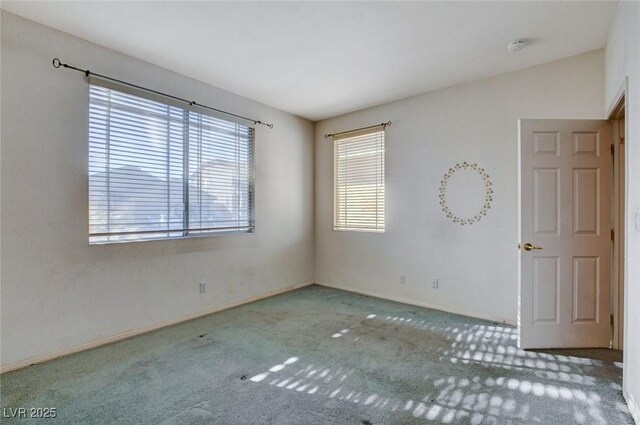 unfurnished room with carpet floors and vaulted ceiling