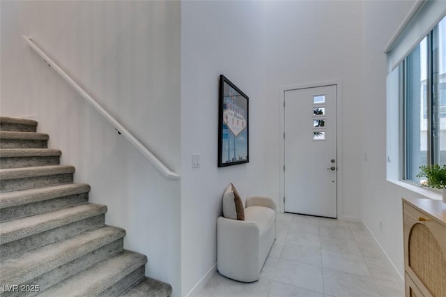 foyer entrance featuring light tile patterned flooring