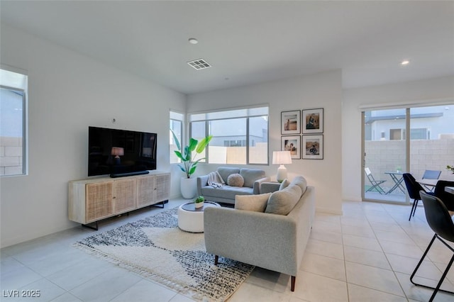 tiled living room featuring a healthy amount of sunlight