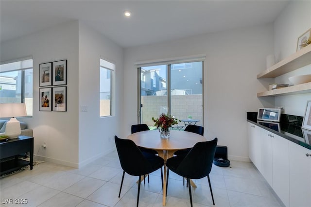 dining area featuring light tile patterned flooring and a healthy amount of sunlight