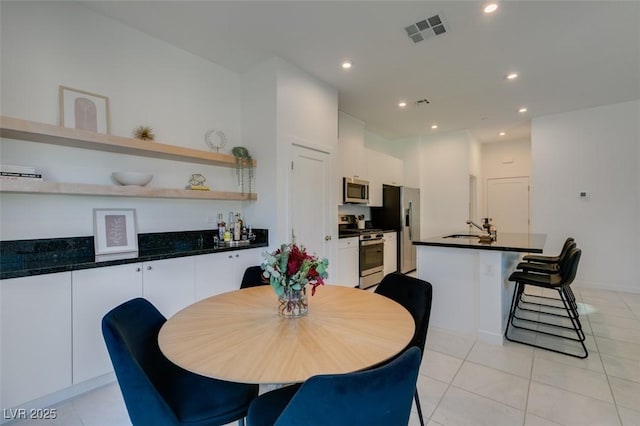 dining area with sink and light tile patterned floors