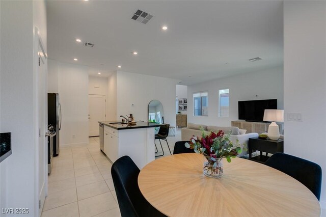 tiled dining space featuring sink