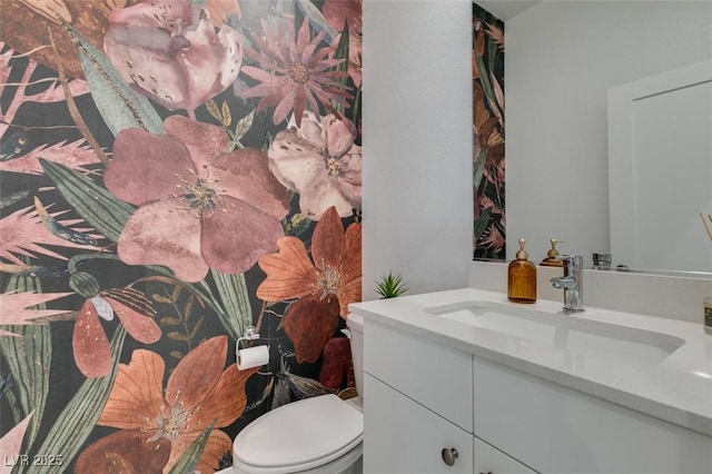 bathroom featuring toilet and vanity