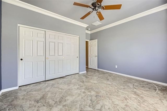 unfurnished bedroom featuring ceiling fan, a closet, and crown molding