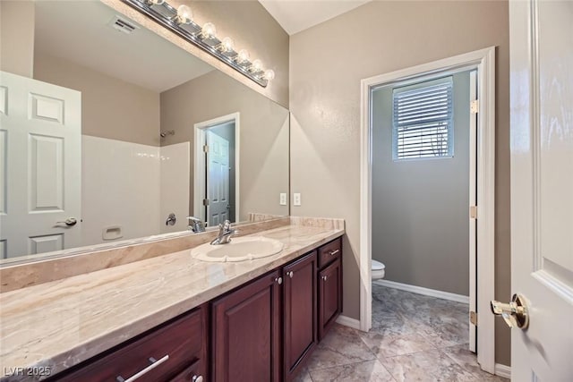 bathroom featuring vanity and toilet