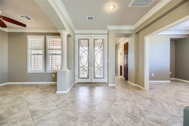 entryway featuring decorative columns, ceiling fan, ornamental molding, and french doors