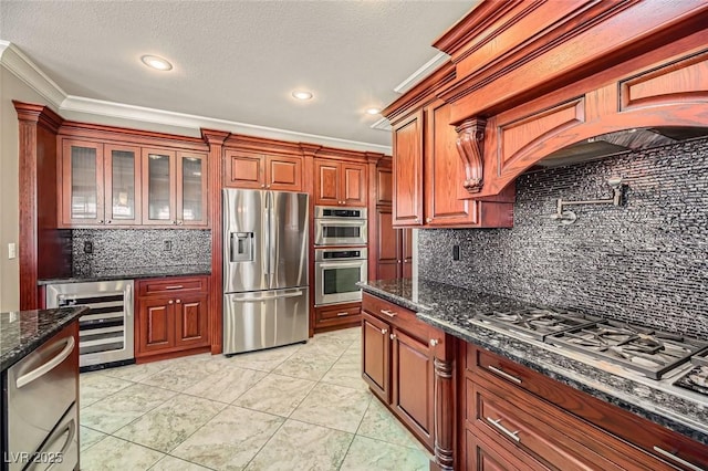 kitchen with appliances with stainless steel finishes, dark stone countertops, wine cooler, backsplash, and ornamental molding