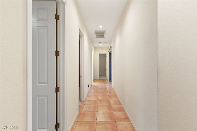 corridor with light tile patterned flooring