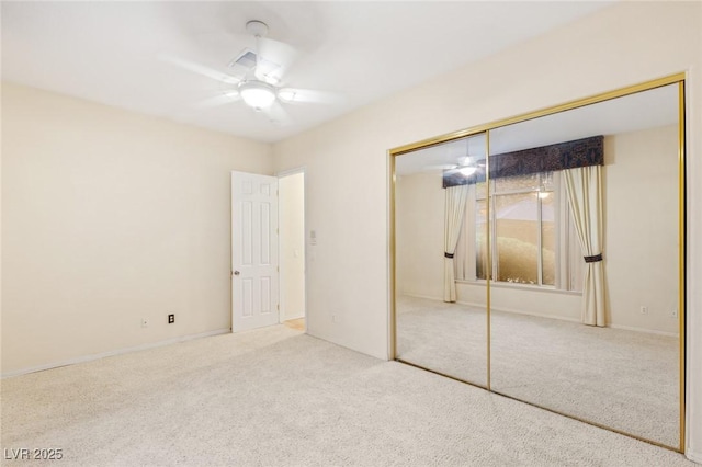 unfurnished bedroom with carpet flooring, a closet, and ceiling fan