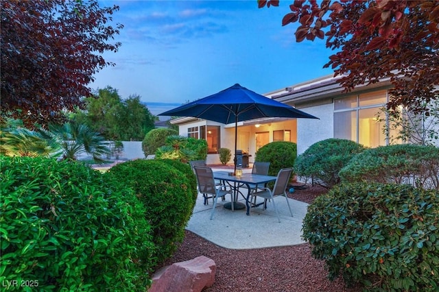 view of patio terrace at dusk