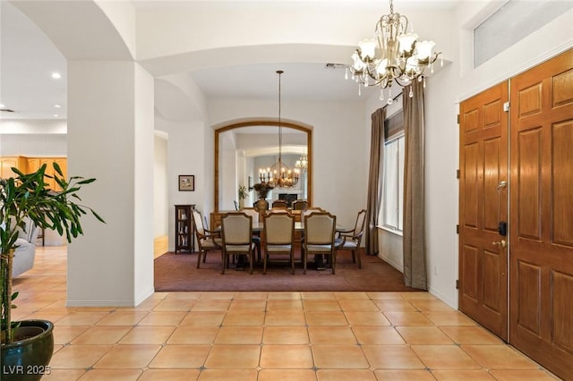 tiled dining space with an inviting chandelier