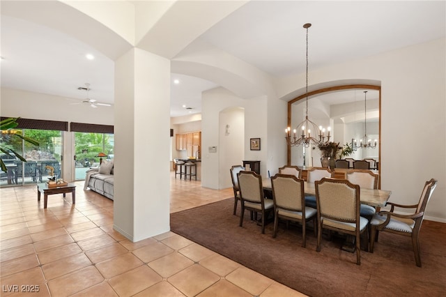 dining area featuring ceiling fan with notable chandelier and light tile patterned floors